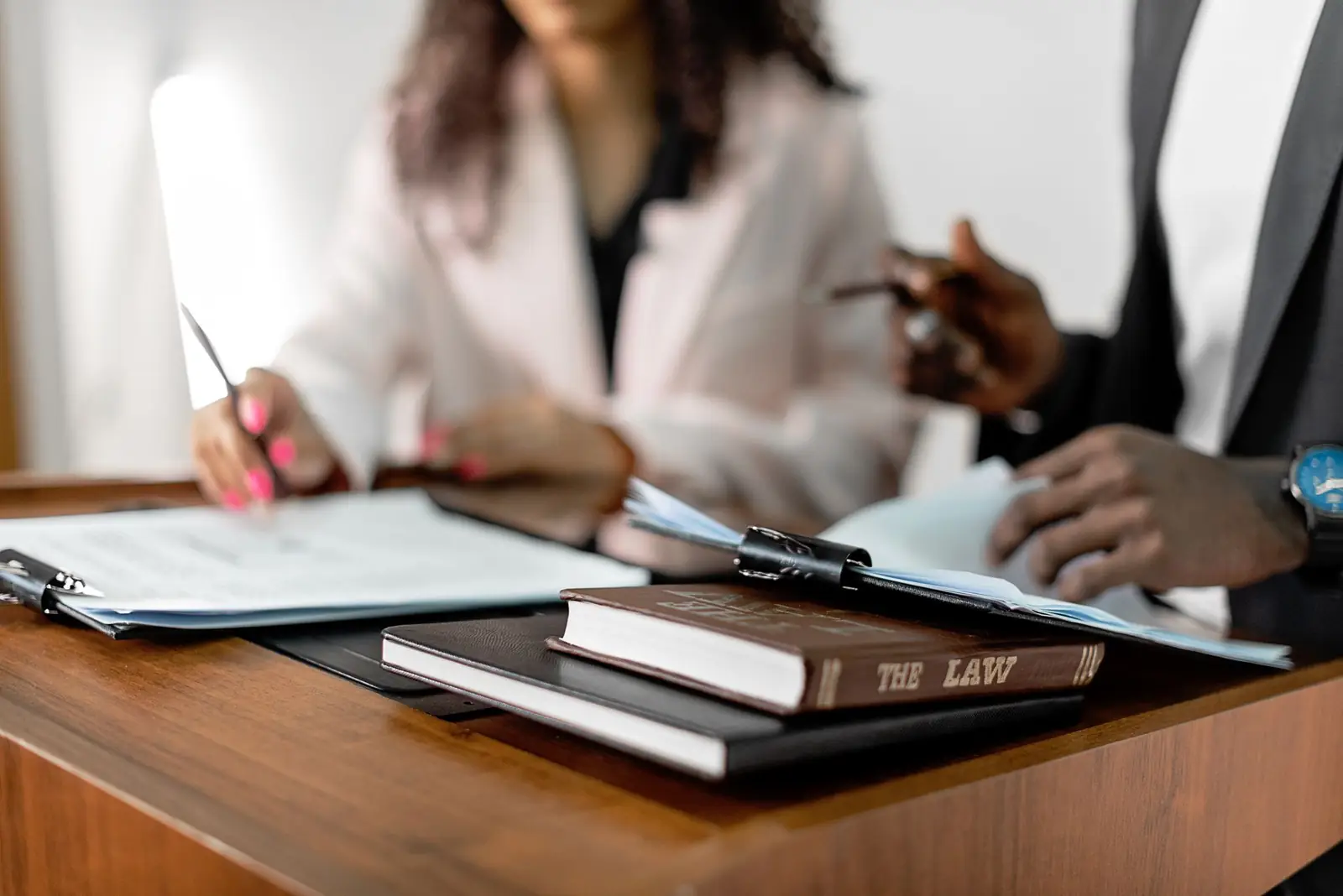 Legal professionals reviewing documents for a court-ordered psychological assessment